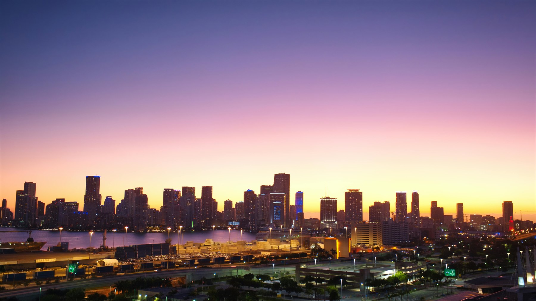 Miami skyline at twilight with a calm bayfront glow for the baby Miami city guide.